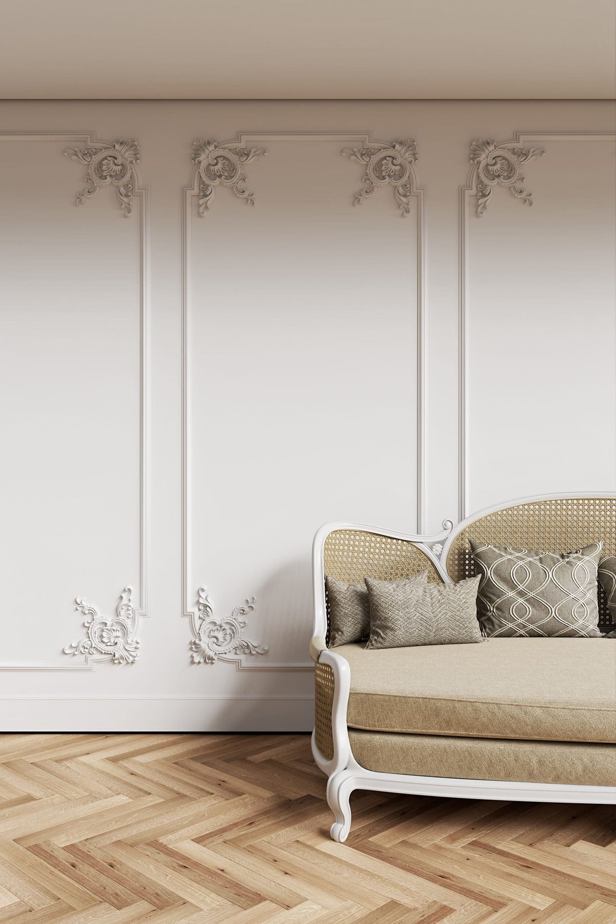 Beige sofa with patterned cushions against a decorative wall with floral designs.
