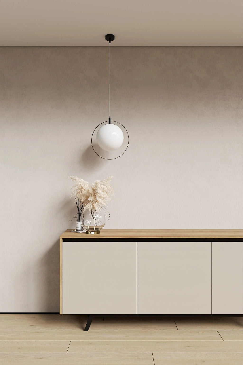 Modern interior with a light-colored sideboard, pendant lamp, and decorative items against a neutral wall.