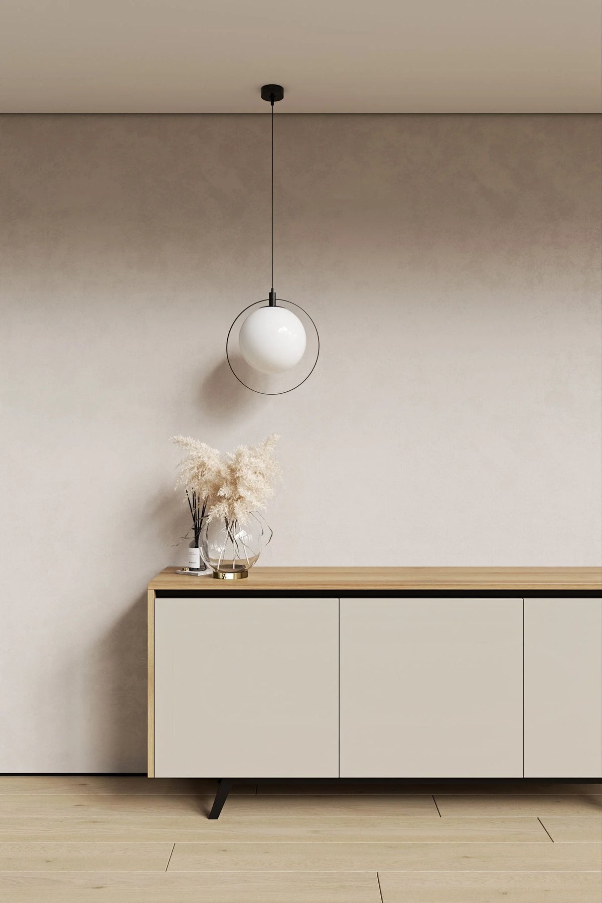 Modern interior with a light-colored sideboard, pendant lamp, and decorative items against a neutral wall.